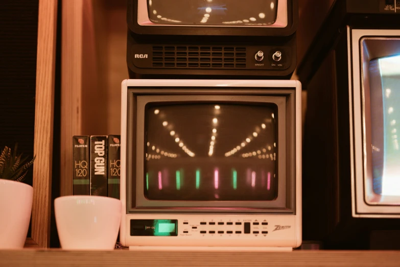 two old - fashioned televisions sitting next to each other