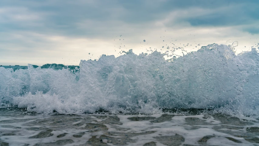 the ocean is splashing up on some waves