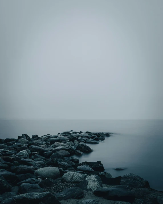 a rock dock on the coast next to the ocean