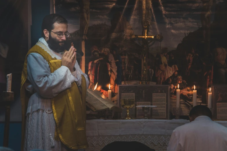 a person in a white robe praying inside of a church