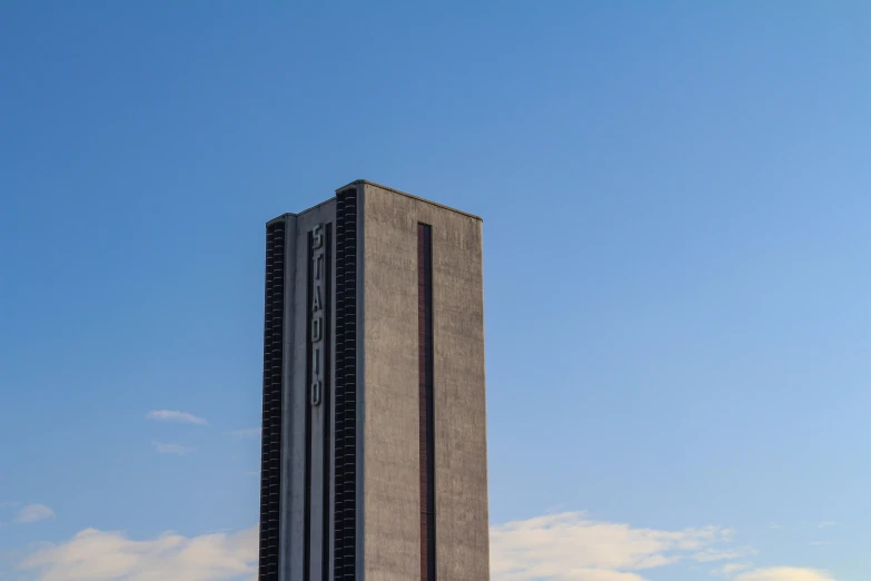 a tall building with many windows is near the sky