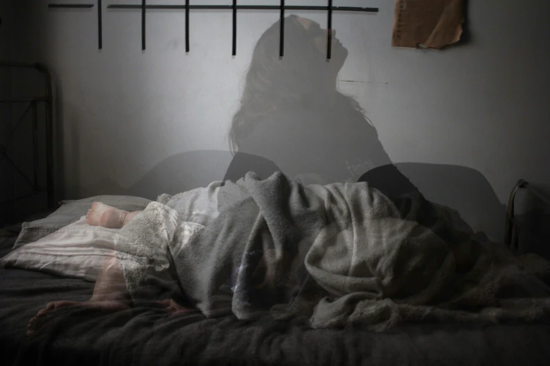 a blurry po of a person laying in a bed
