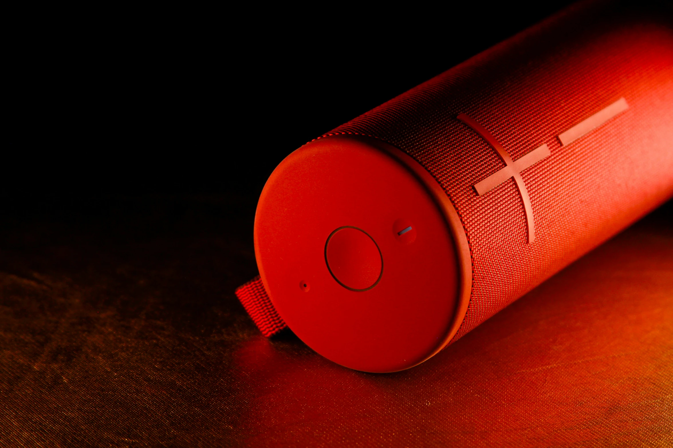 an orange wireless speaker with white accents sitting on top of a table