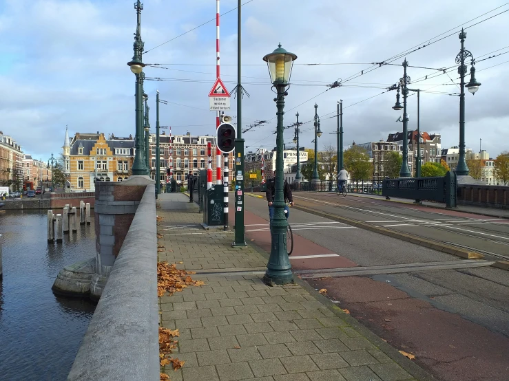 an old - fashioned bridge leads into a modern city