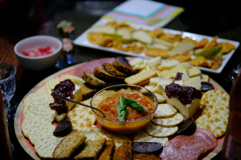 many cheeses and ers are spread out on this platter