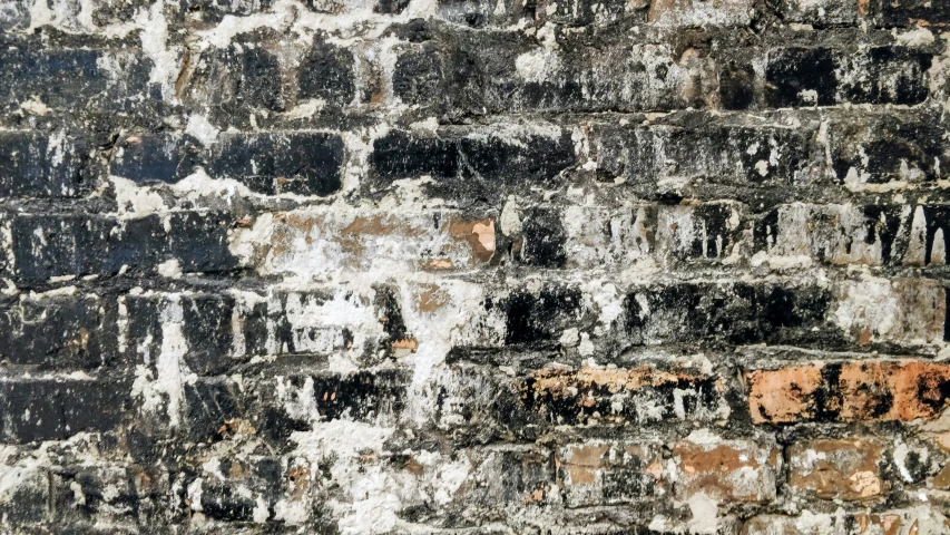 grungy brick wall with lots of black and orange patches