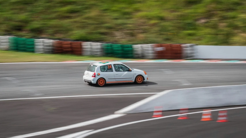 a small white car on a race track