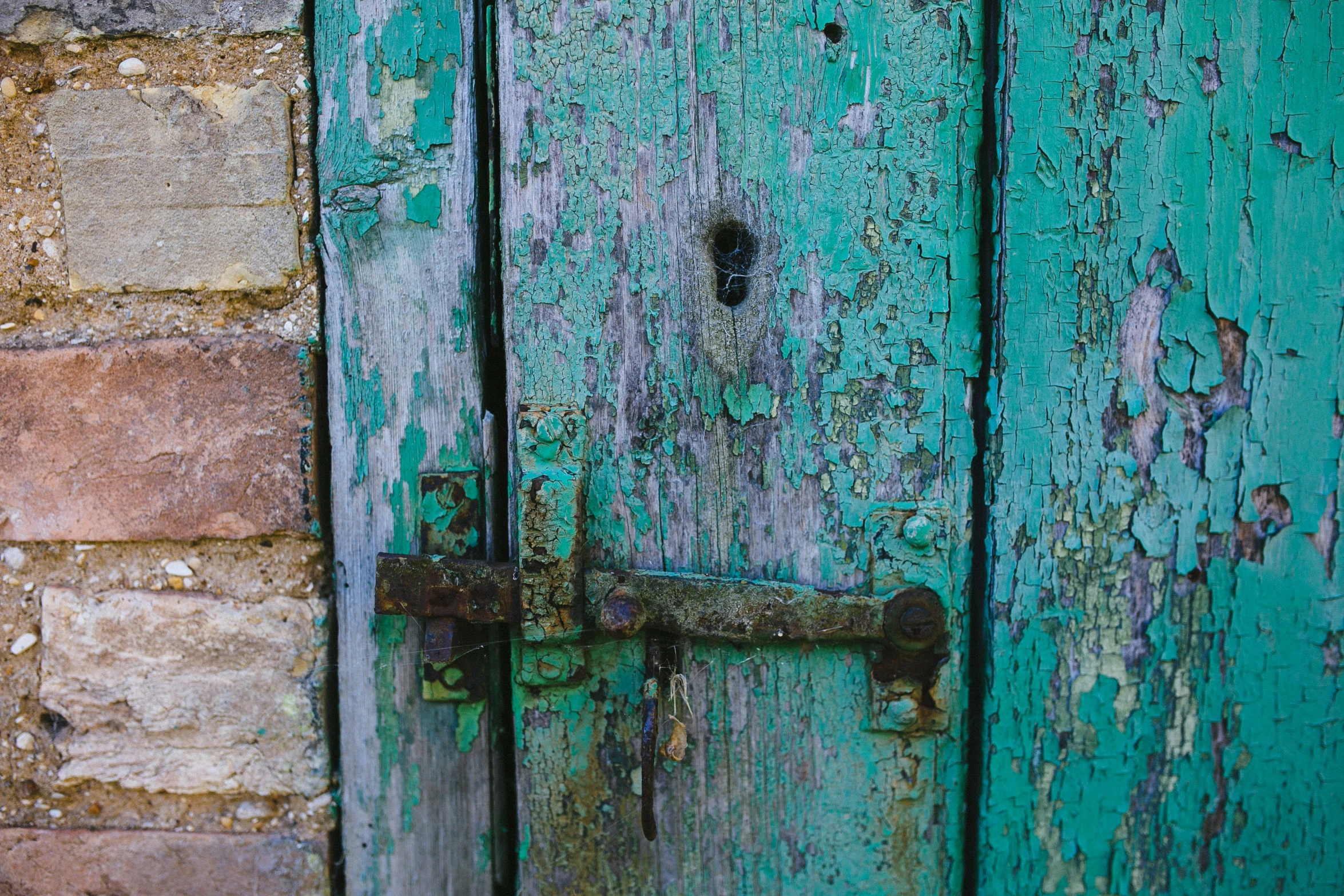 a door with a handle painted blue and green