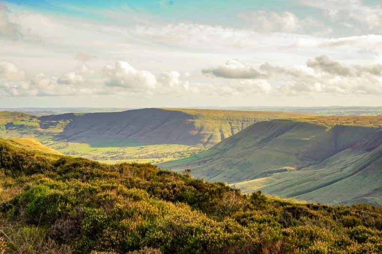 a view looking down a mountain valley in the sunlight