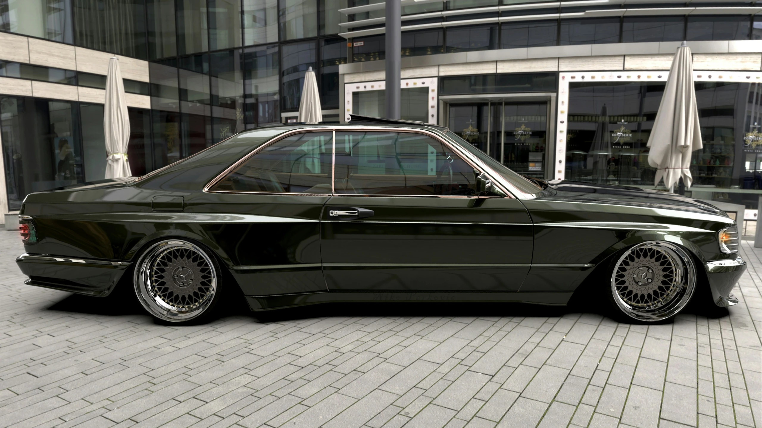 a black mercedes parked in front of an office building