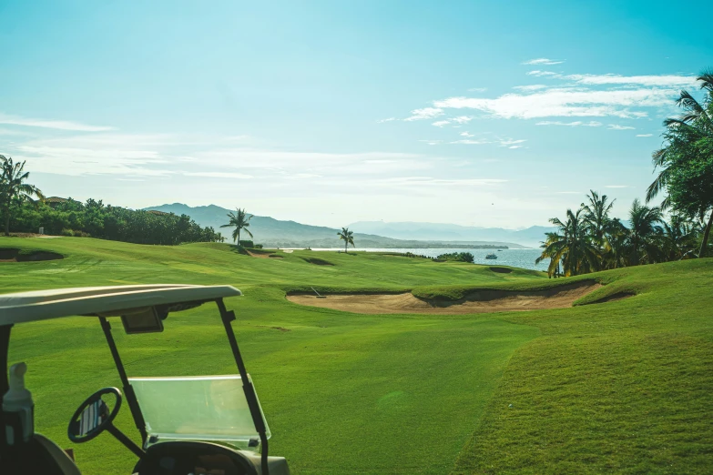 an open green golf course near a body of water