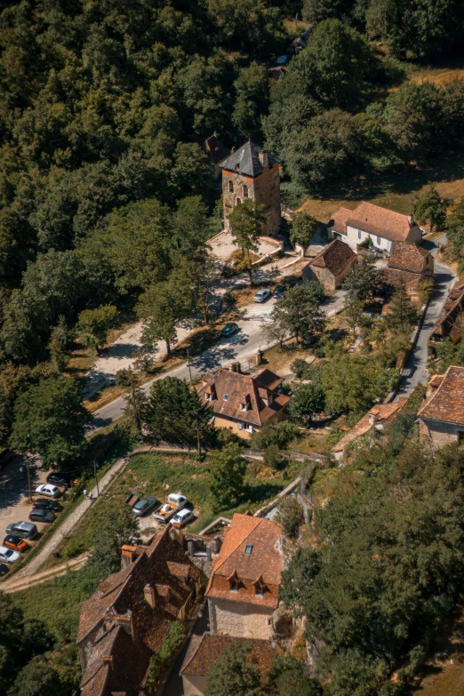 an old building surrounded by trees near a small river