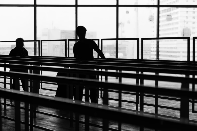 two people standing and waiting in an empty airport