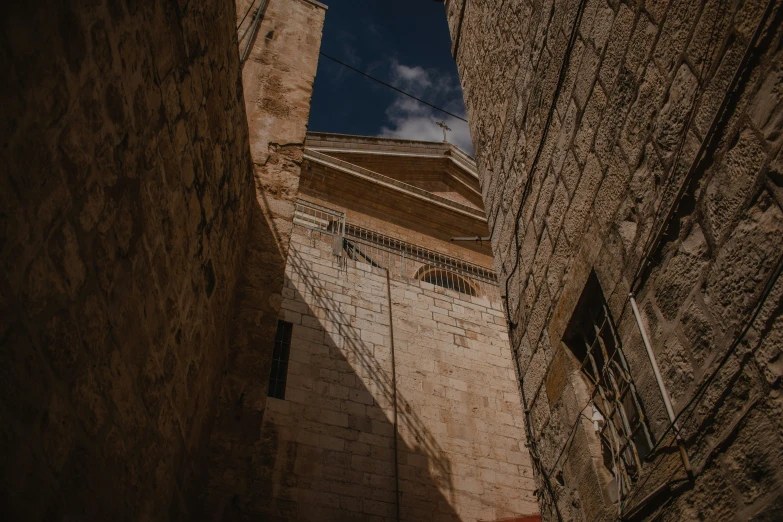 the back of a tall brick building with a clock tower