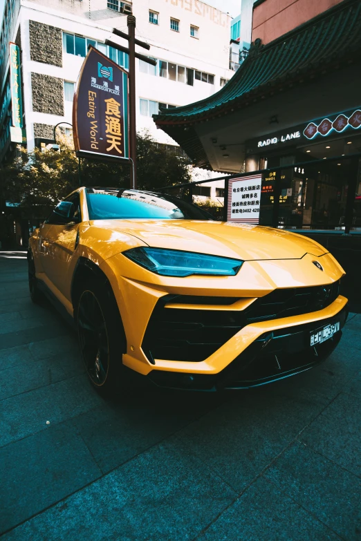 yellow sports car in front of an oriental restaurant