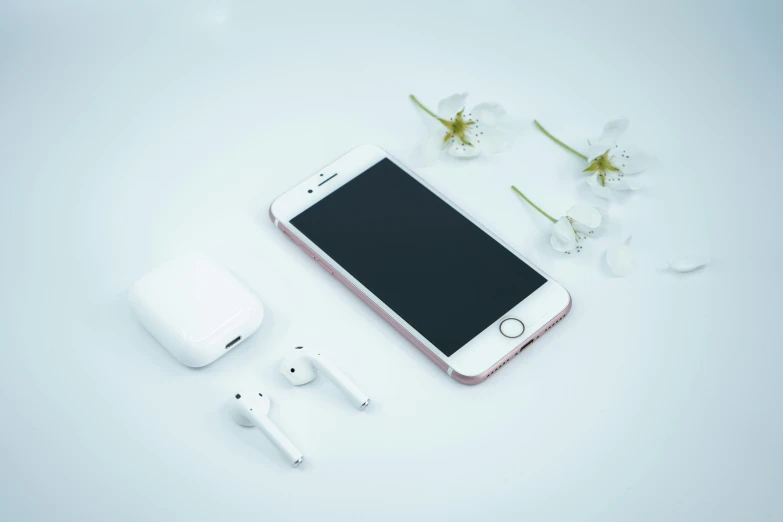 an apple watch, an airpods, and a flower