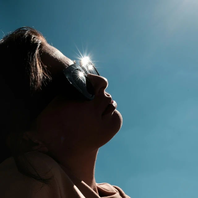 the back side of a woman wearing sun glasses