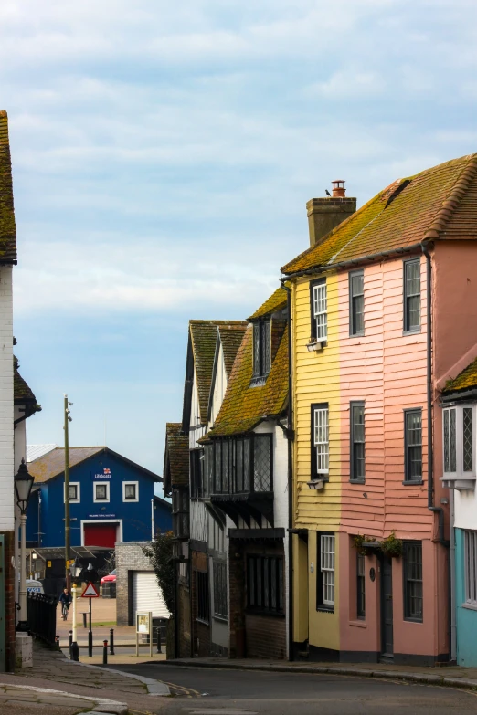 several houses are colorful in front of blue, white, and red