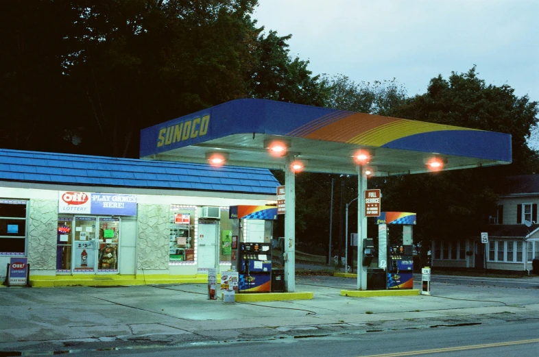 a gas station has an empty lot next to it