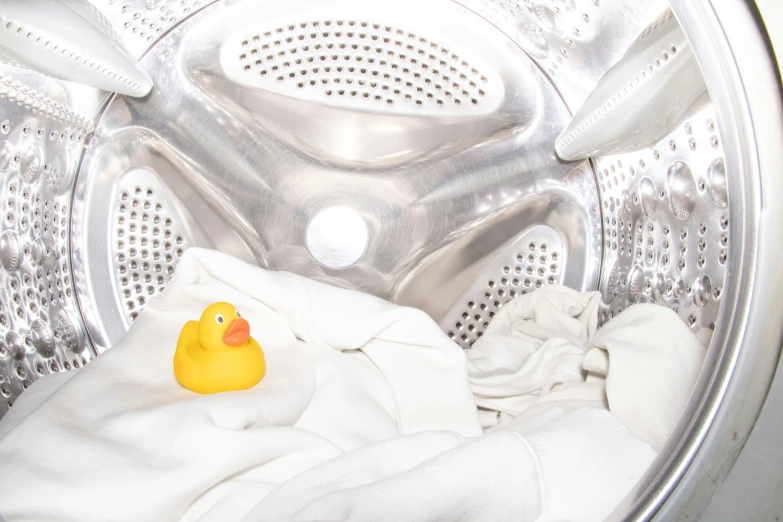 a rubber ducky toy sitting inside a washer