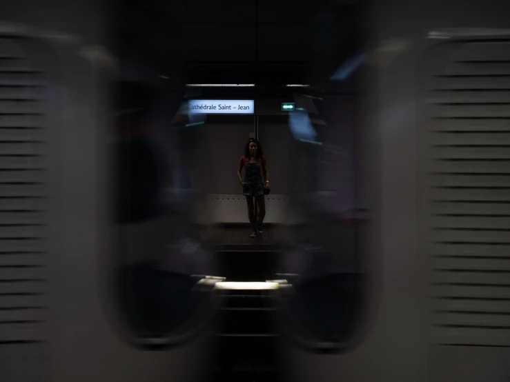 a person standing on a train platform in the distance