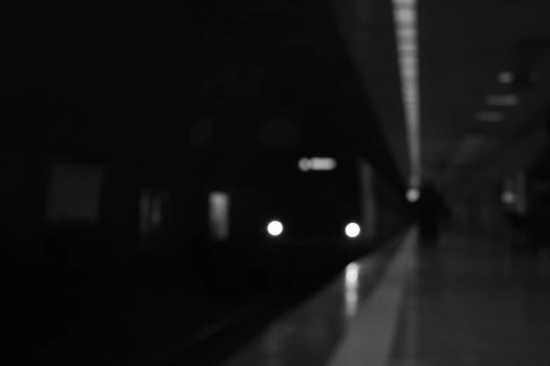 two subway cars on the tracks at a station