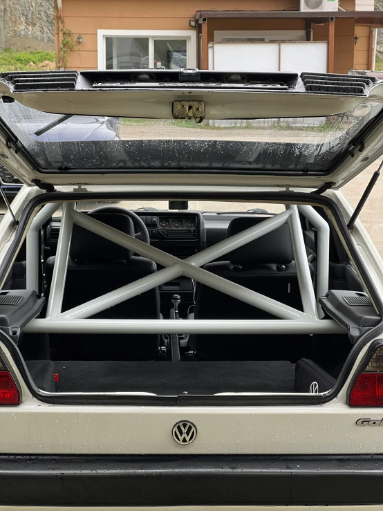 a car has an open top, with the back door opened