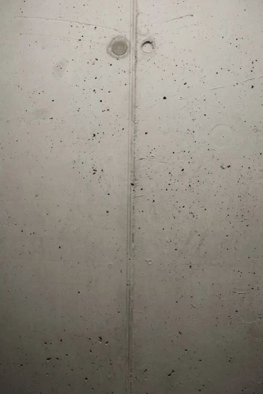 the side of a cement wall with dots that are made to look like an arrow