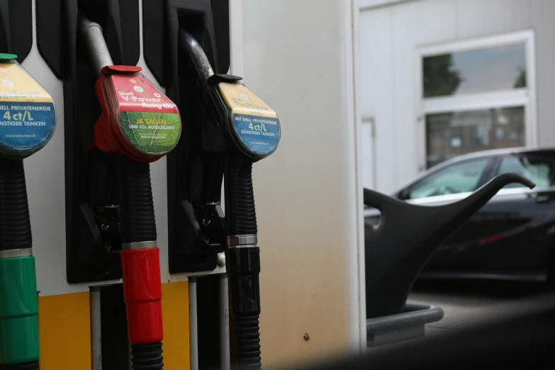 the cars are lined up at the gas station