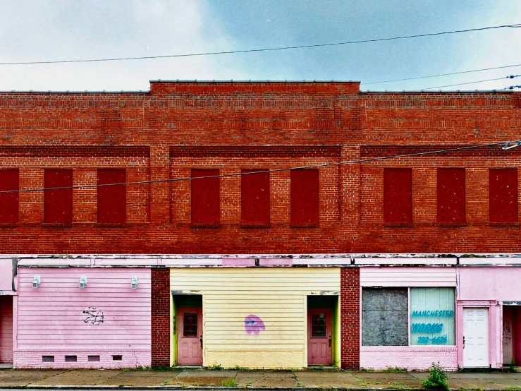 a red brick building with several different color windows