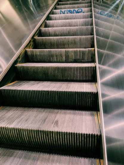 a stairway inside a subway with stainless steel steps