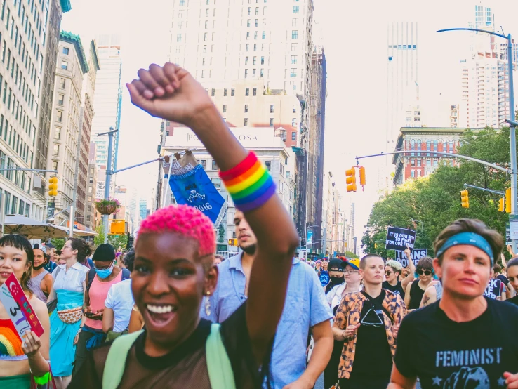 a woman with her arm in the air at a rally