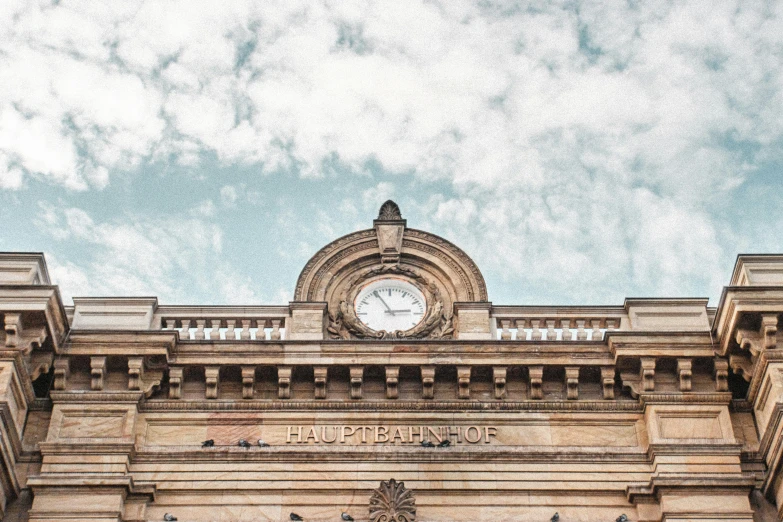 the clock is on top of a large building