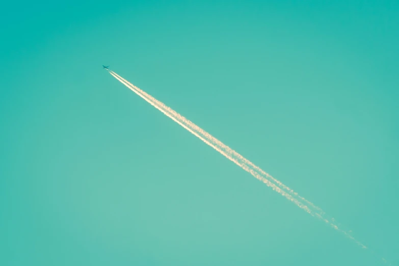 a jet flying through the sky while being pulled by an airplane