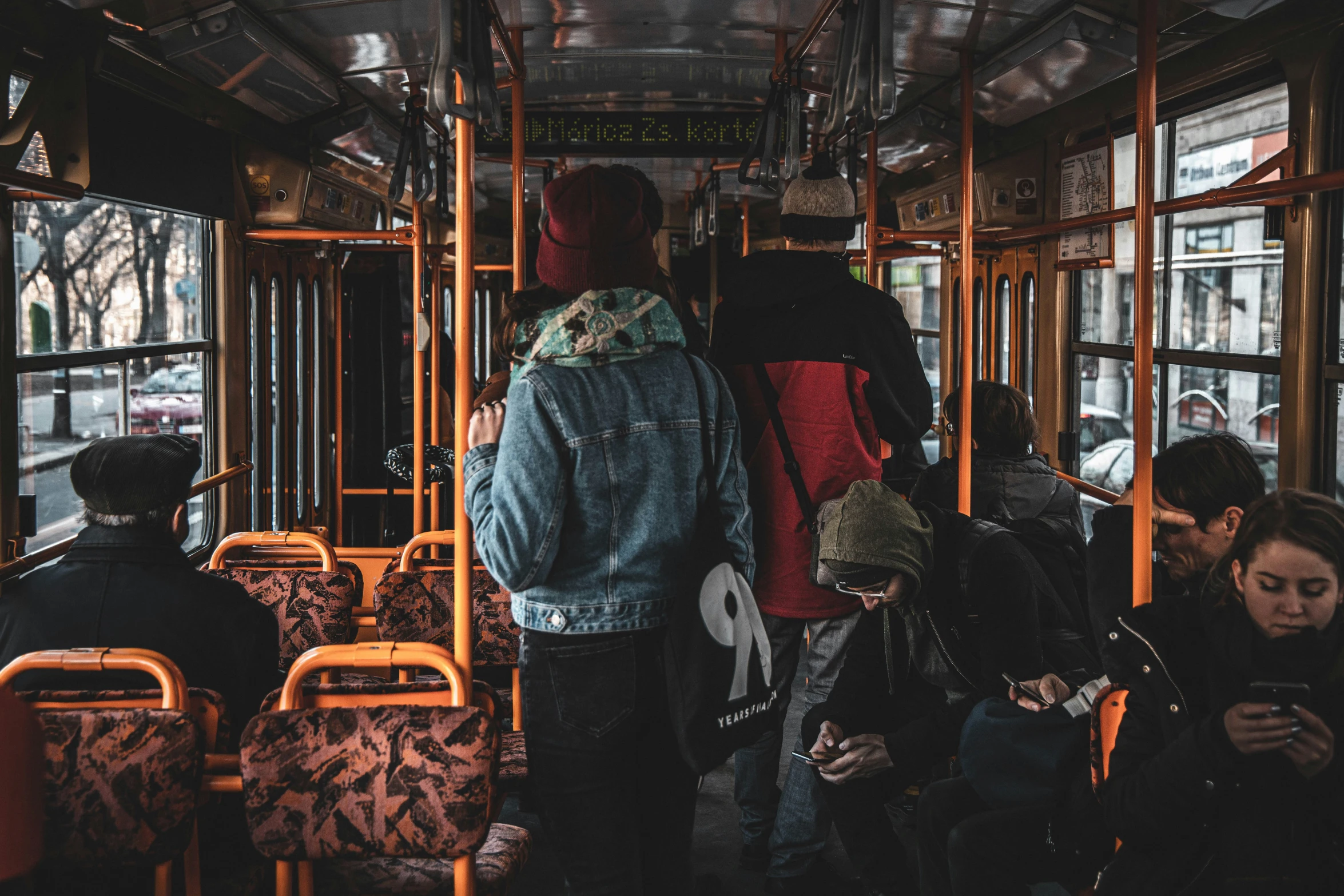 several people are sitting on a bus together