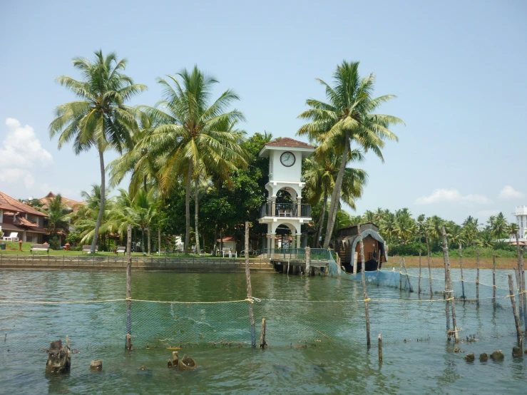 a large building sitting next to trees and water