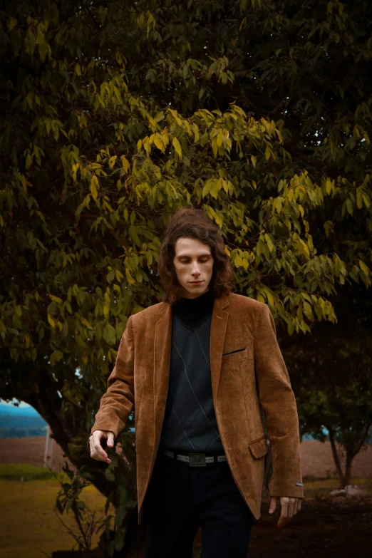 a man is standing under a tree outside