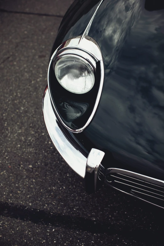 a closeup of the headlight of a black vintage car