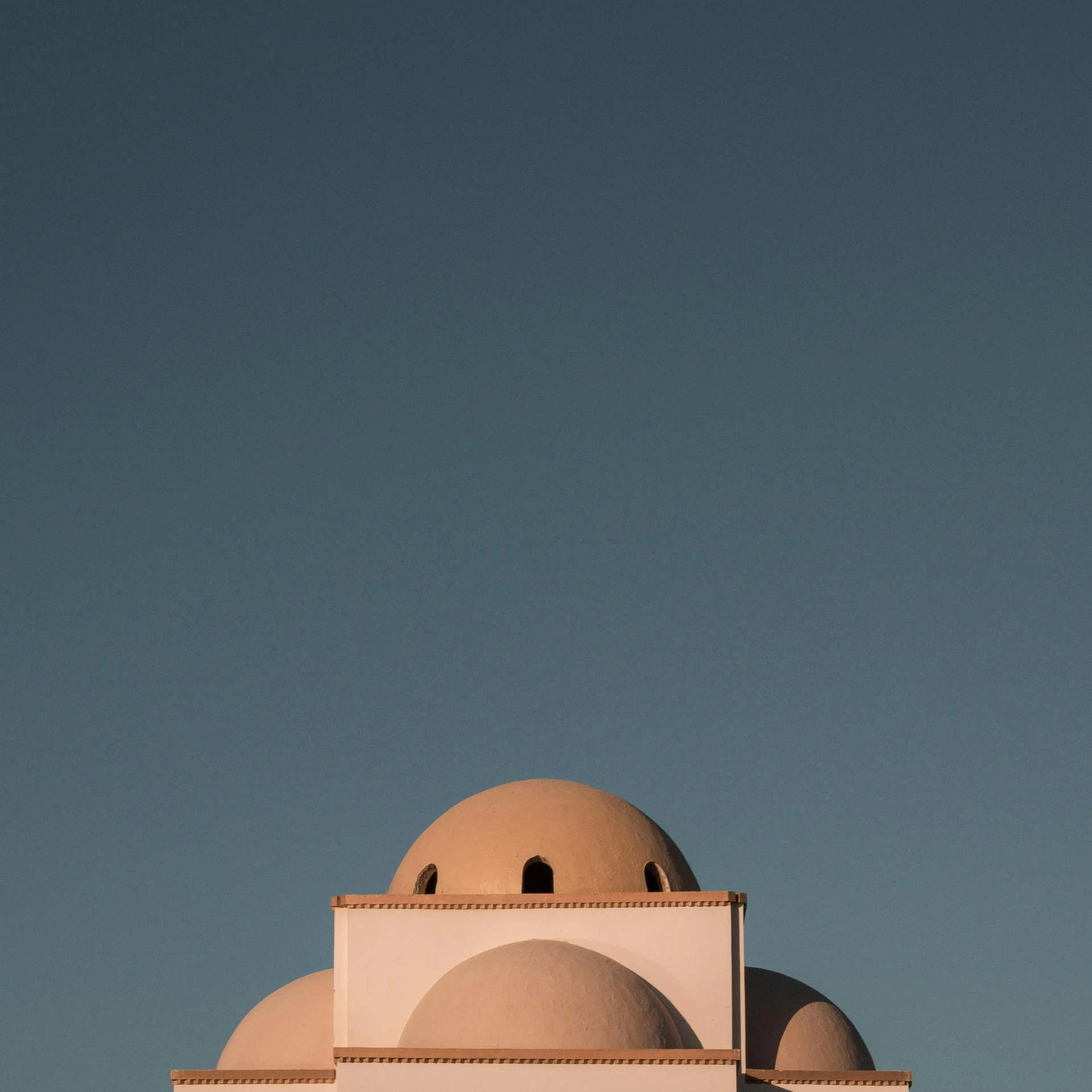 a building with a steeple is surrounded by a blue sky