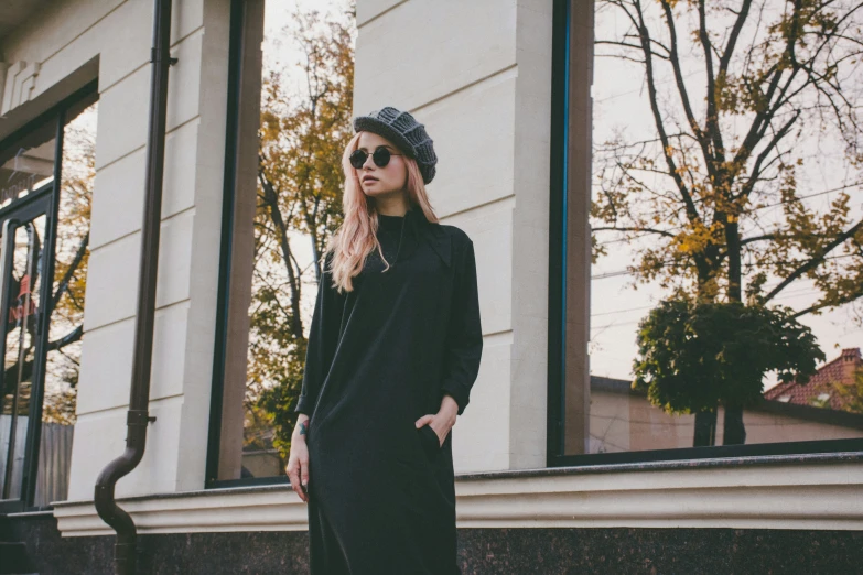 a girl is standing outside in the sun