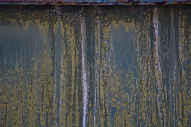 rusted metal surface in different stages of decay and peeling