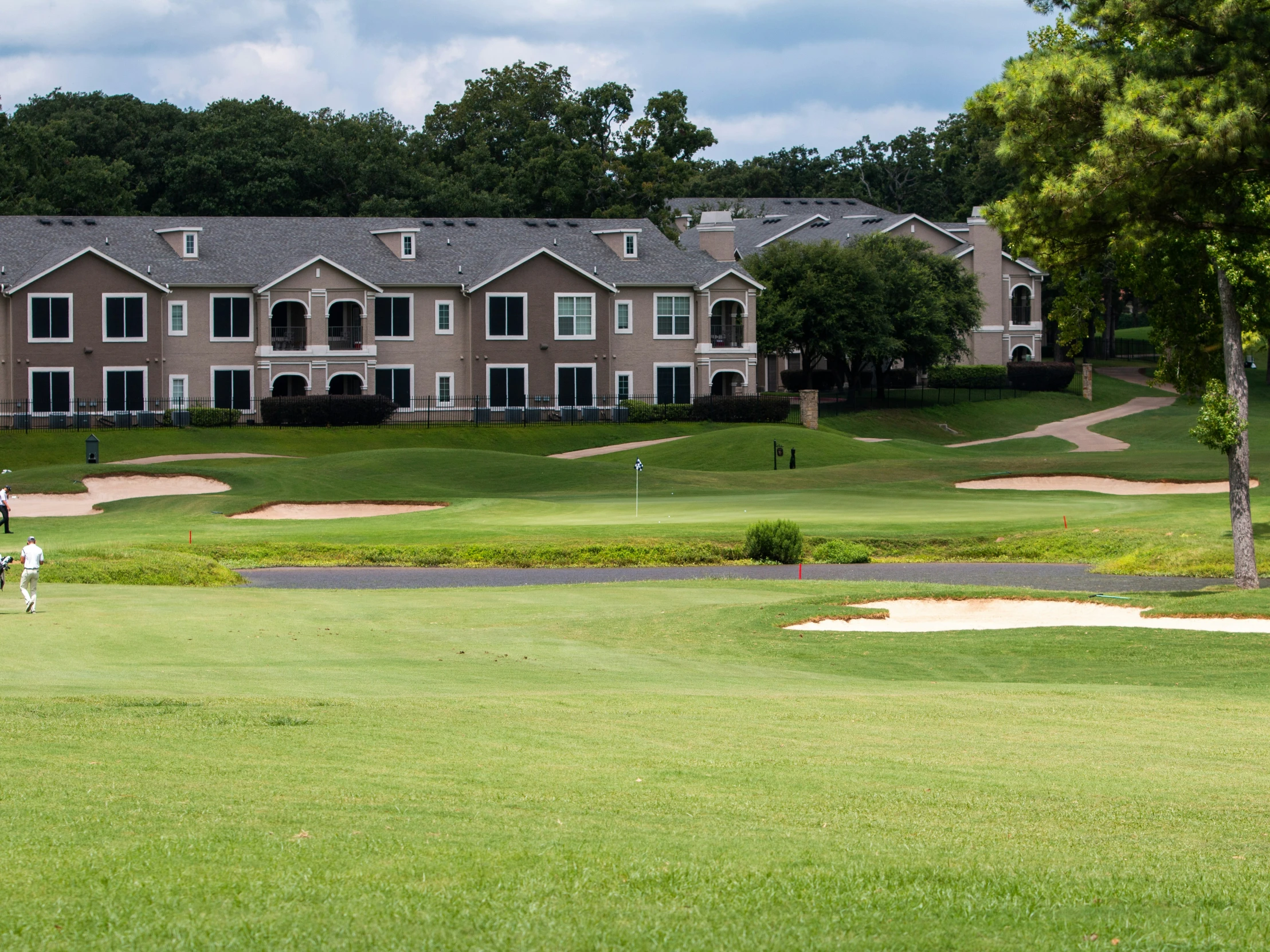 a view of several buildings and people playing golf