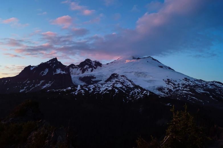 a very tall mountain is covered in snow