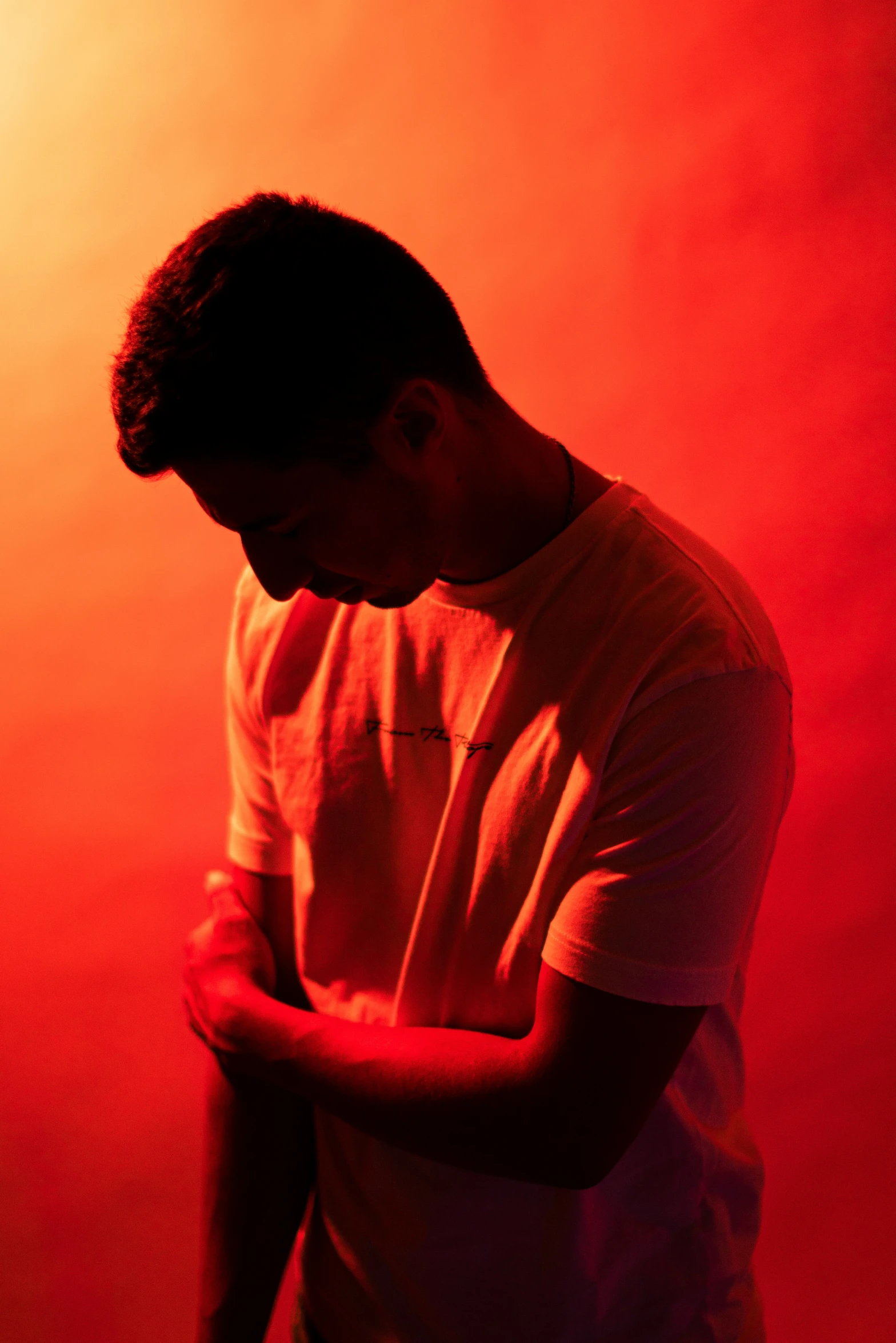 young man holding his head while looking down