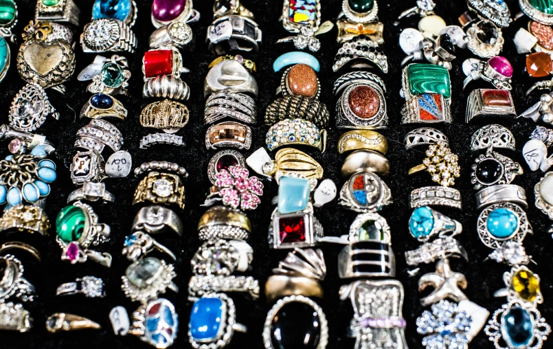 an array of rings are arranged neatly for sale