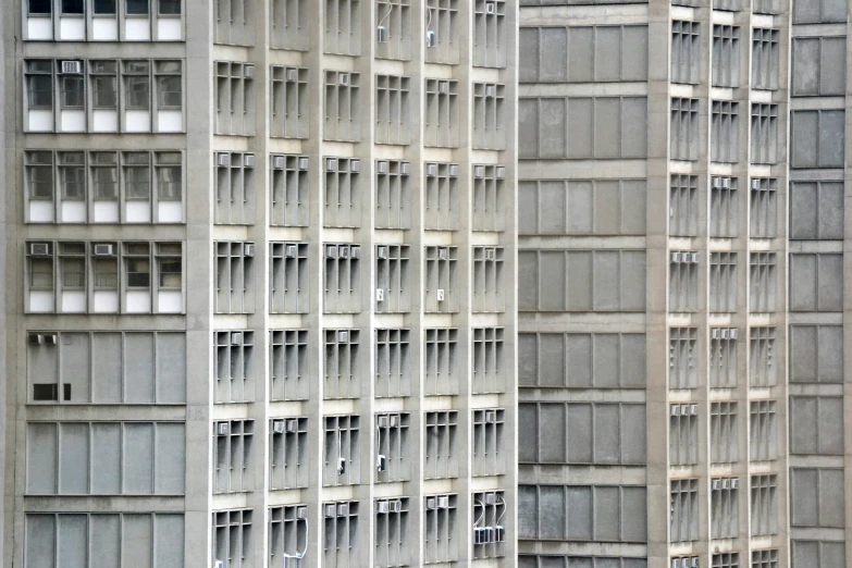 two buildings side by side each with various windows and door opening