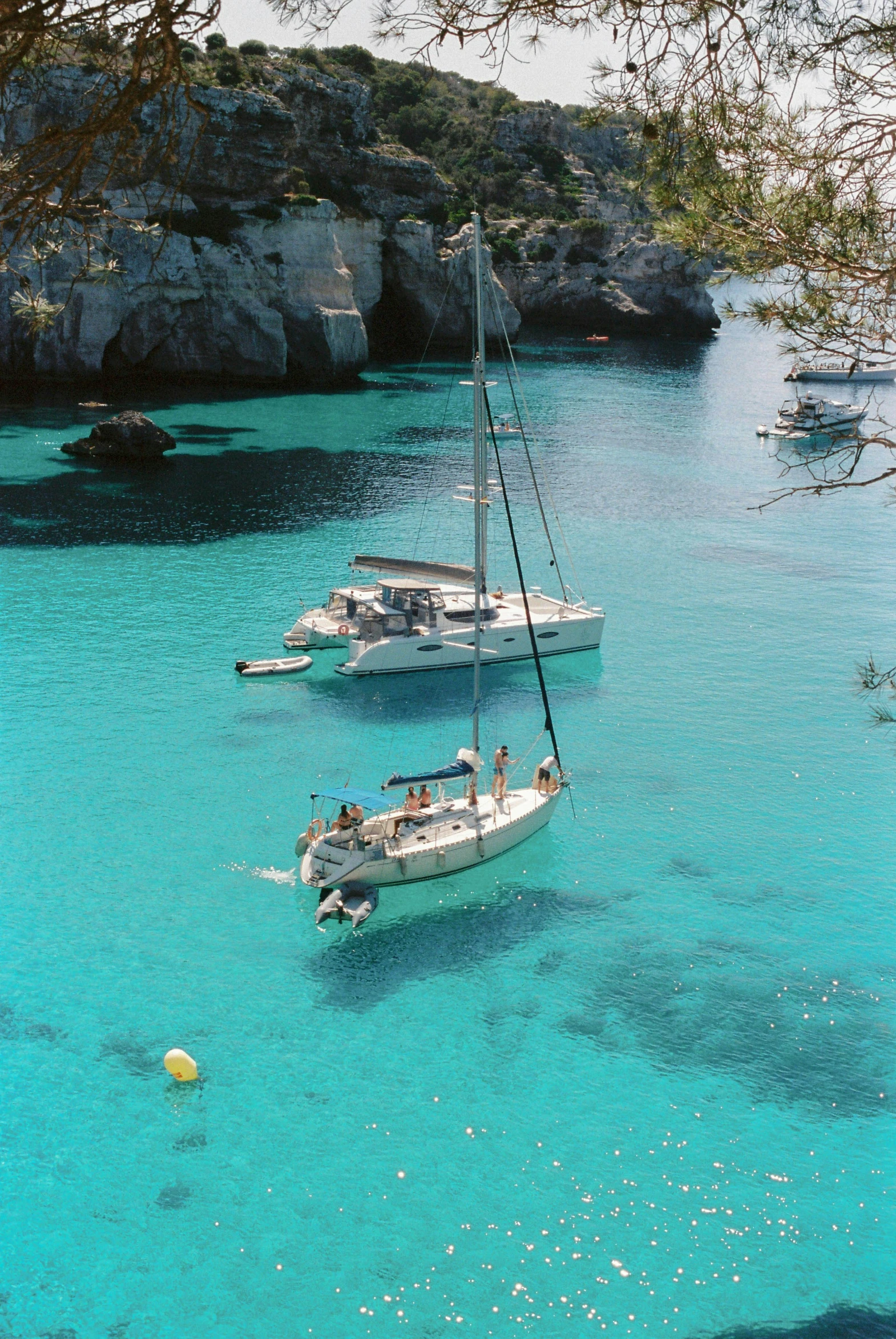 a couple of boats floating on top of a lake