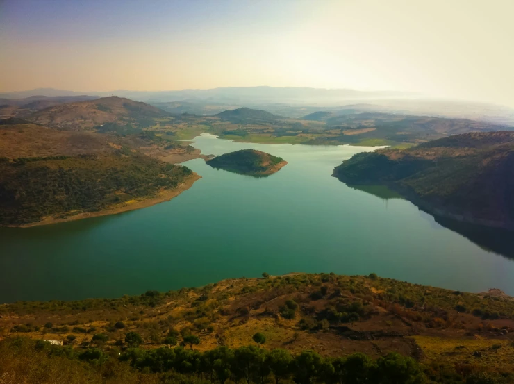 the view from a plane of a small lake and trees