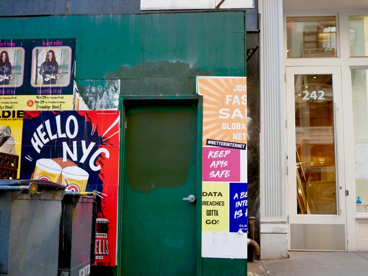 there is a door on the side of a building with many signs