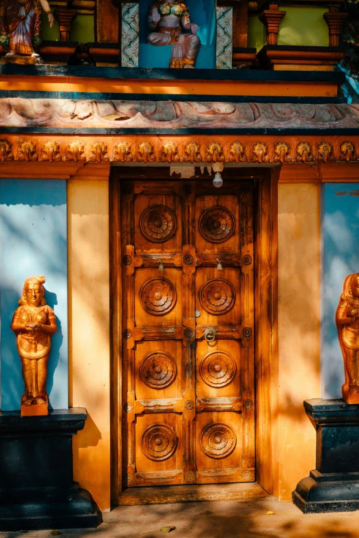 a door with statues on each side of it